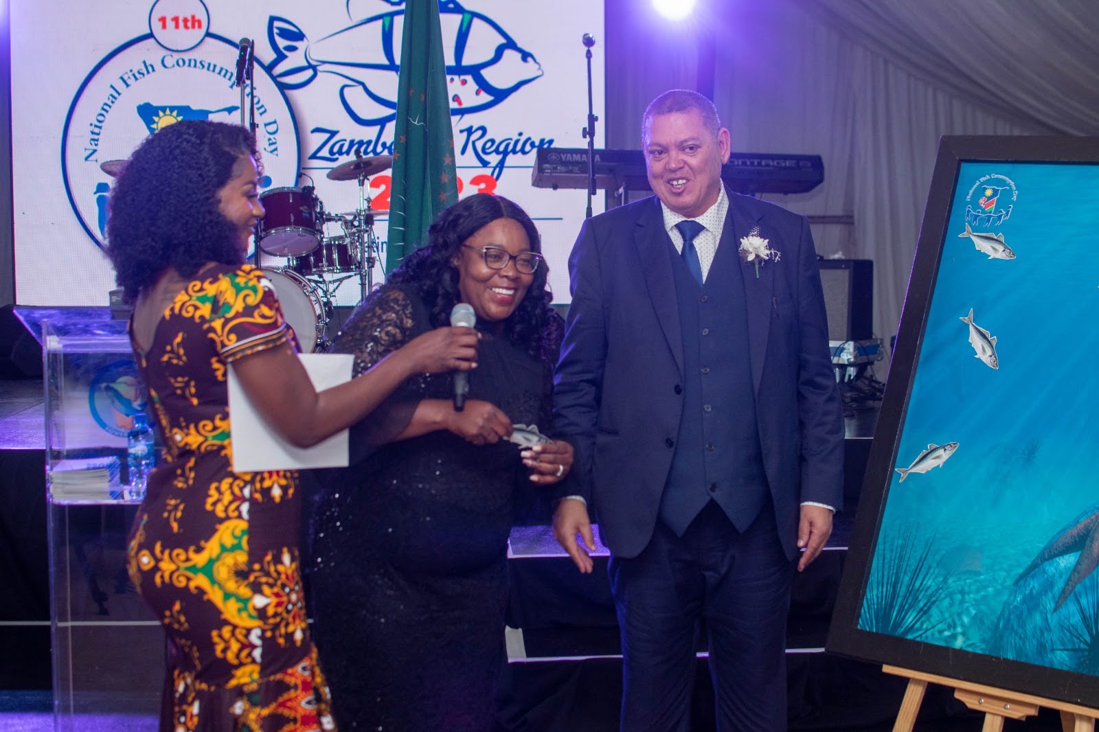 Lorraine Kondombolo facilitating a ceremonial presentation on stage