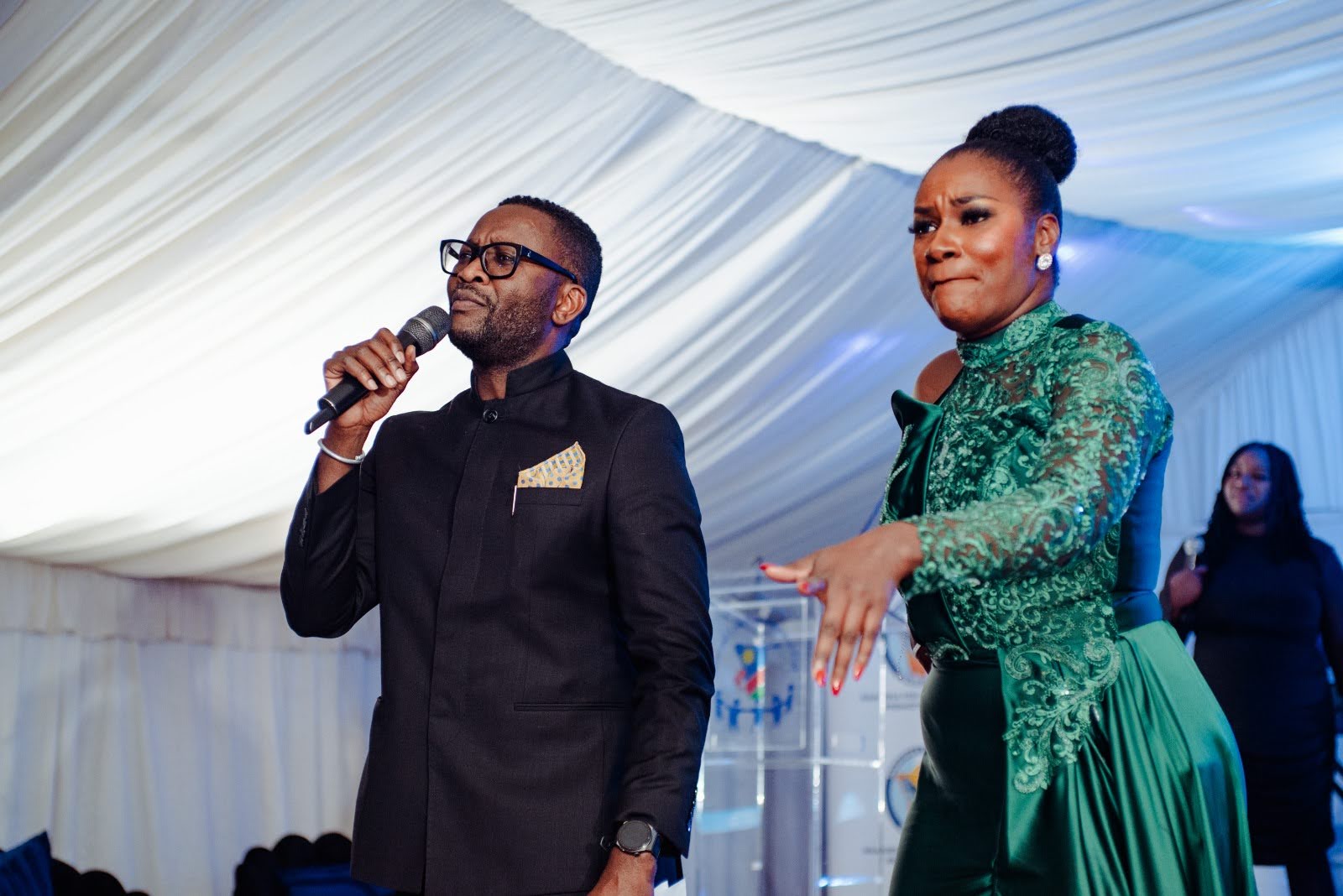 Lorraine Kondombolo sharing the stage with a fellow host during a gala