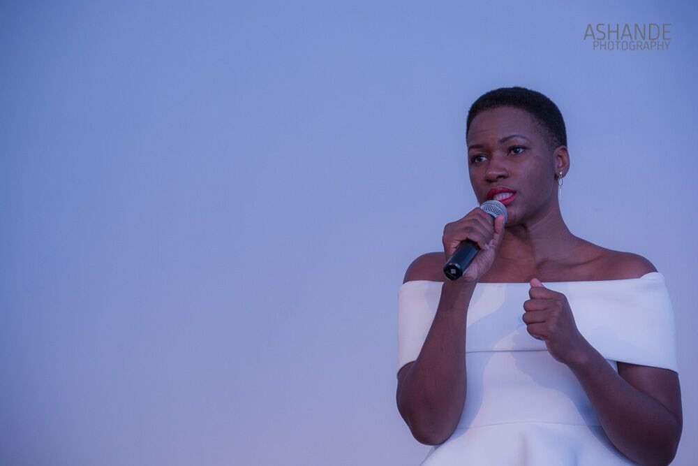 Lorraine delivering a presentation in white